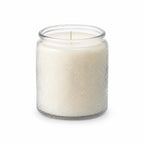 Unlit embossed glass soy candle centered on a pure white background