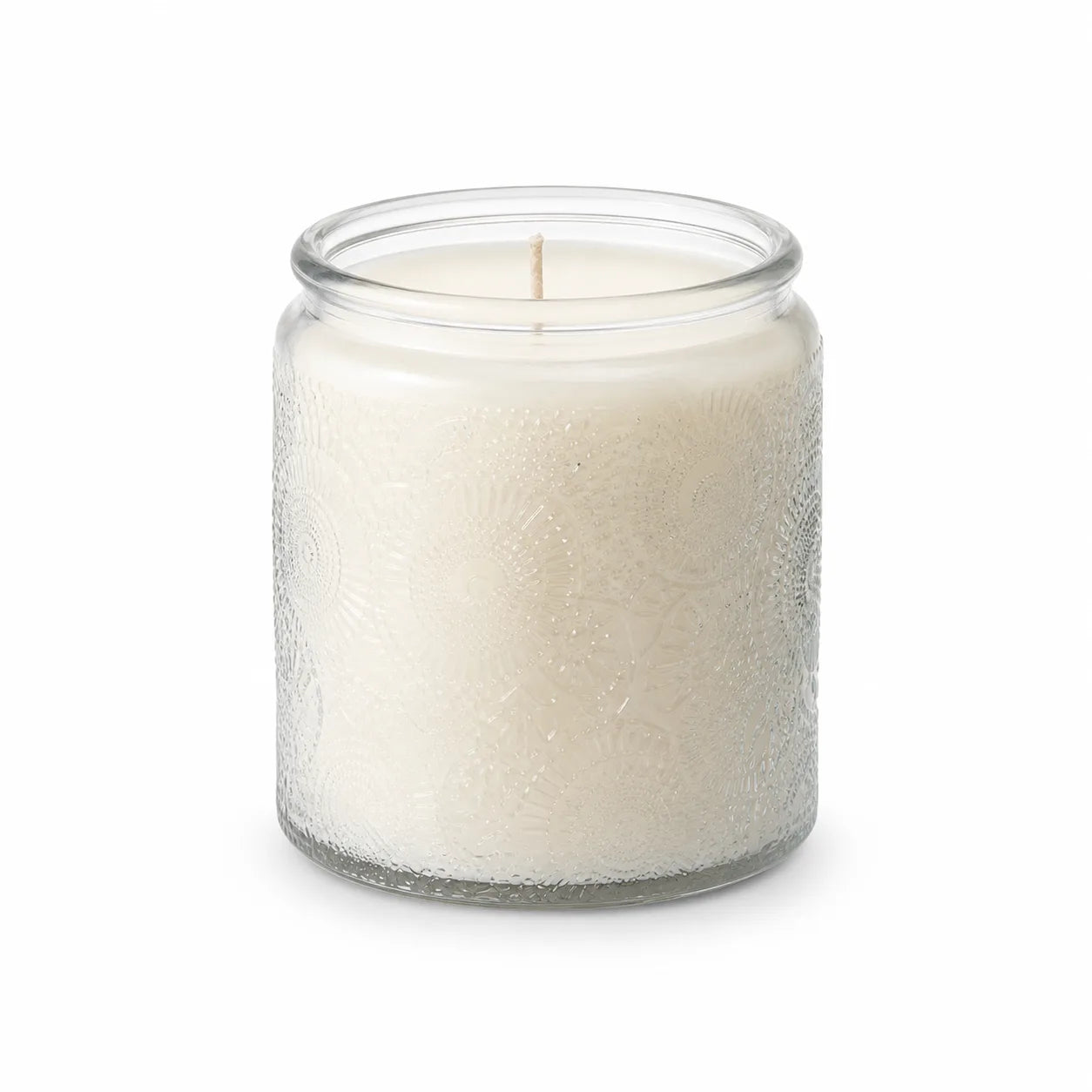 Unlit embossed glass soy candle centered on a pure white background