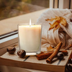 Clear candle jar in a warm seasonal scene