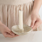 Ceramic taper holders on a dining table